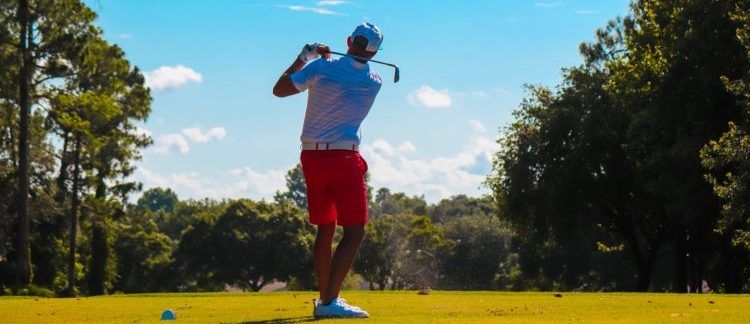 man playing golf on a sunny day