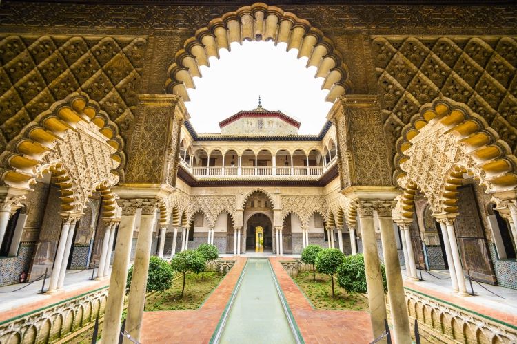 things to do in andalusia | SEVILLE, SPAIN - CIRA 2014: The Royal Alcazar of Seville at the Courtyard of the Maidens. It is the oldest royal palace still in use in Europe.