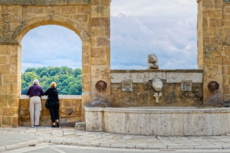 Elderly couple watching the view from the village of Pitigliano, Tuscany  | best group activities in Tuscany