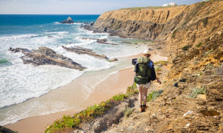 hiker on hiking trail along coast portugal , rota vicentina. HDR image