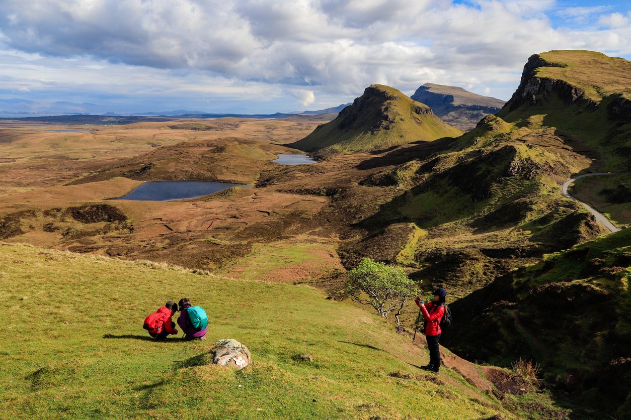 This image shows happy family enjoying the Quiraings stunning view - Scotland travel guide