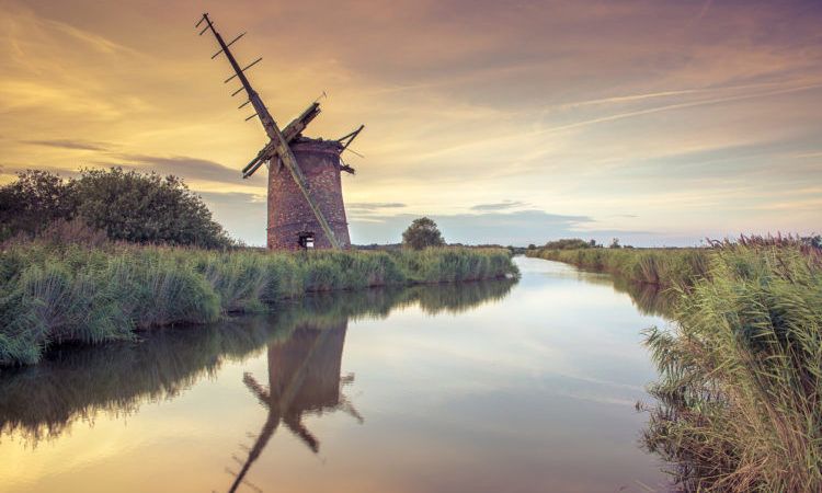 Abandoned Windmill on norfolk broads at sunset