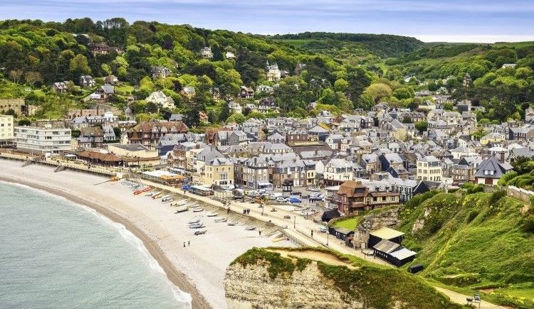 Etretat village and its bay beach, aerial view from cliff. Normandy, France, Europe. Long exposure photography