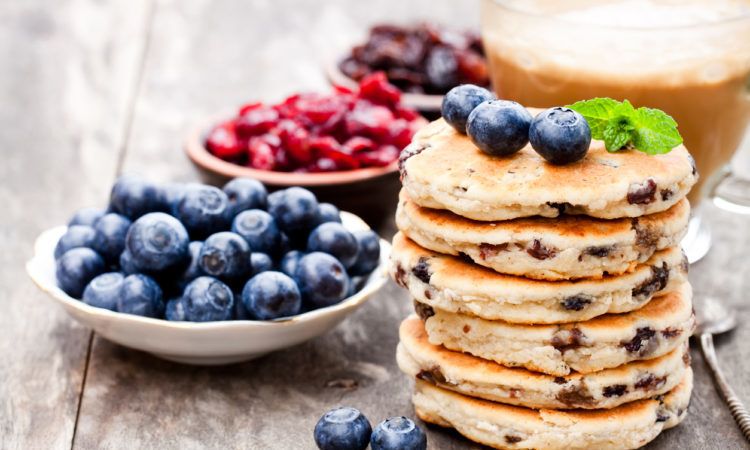 Stack of welsh cakes with blueberry and a cup of coffee