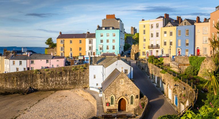 Pastel Coloured Town Houses overlooking the Harbour at Sunset. Tenby, Wales, UK.