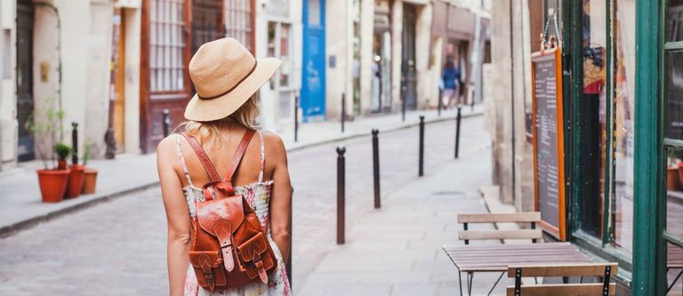 woman tourist on the street, summer fashion style, travel to Europe