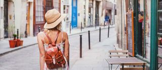 woman tourist on the street, summer fashion style, travel to Europe