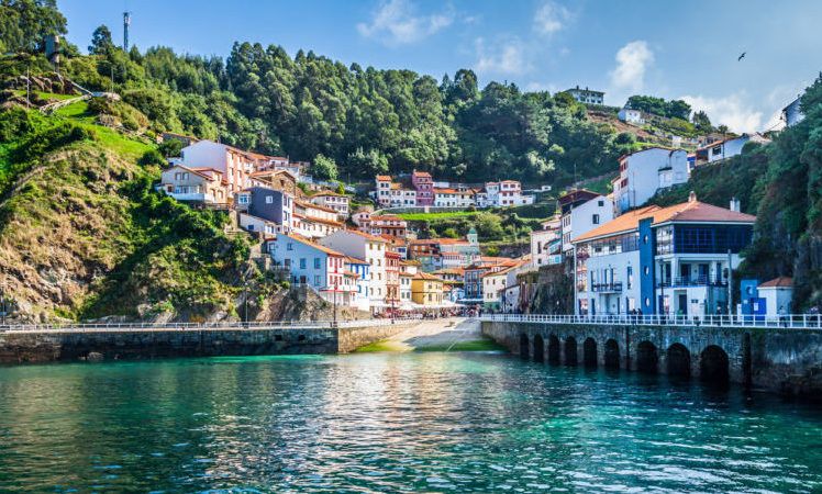 Fishing village in Asturias from the ocean angle, looking up to mountainous scenery