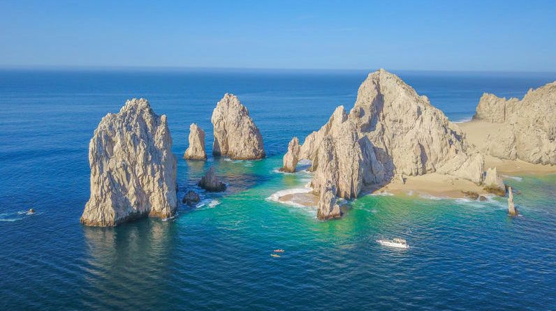 Aerial drone picture of cliffs, sand and emerald green water inin Cabo San Lucas