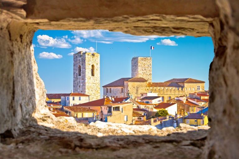 Old Town Of Antibes, Seafront And Rooftops View Through Stone Window