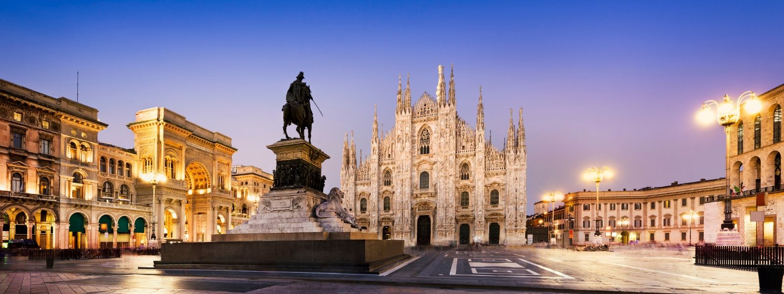 Square lit up at night in Milan