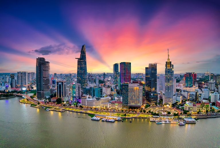Aerial View Of Beautiful Skyscrapers Along The River At Sunset Sky