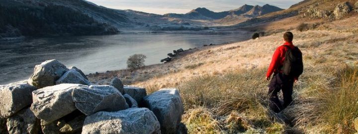 Man hiking along the river at Snowdonia Mountain, Wales