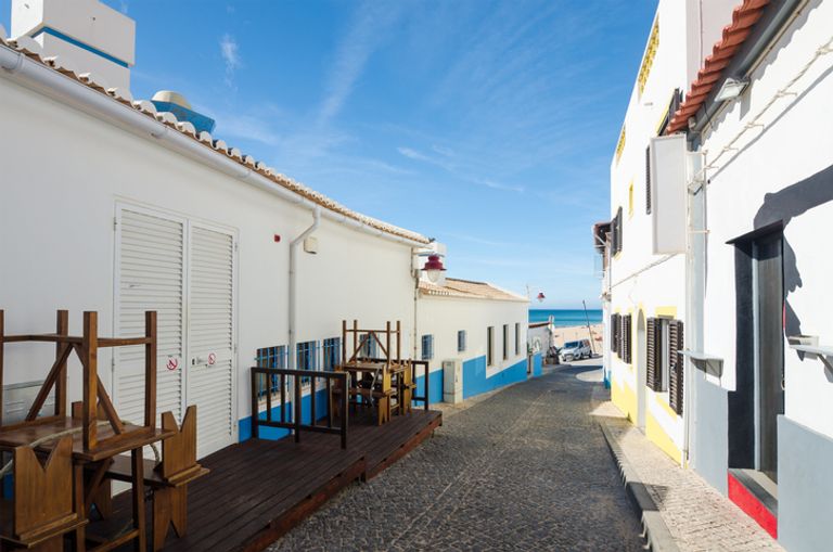 Whitewashed houses in narrow street in Salema Village