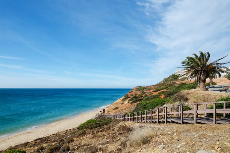 Wooden Stairway Leading To The Beautiful Sandy Beach Of Salema Village.