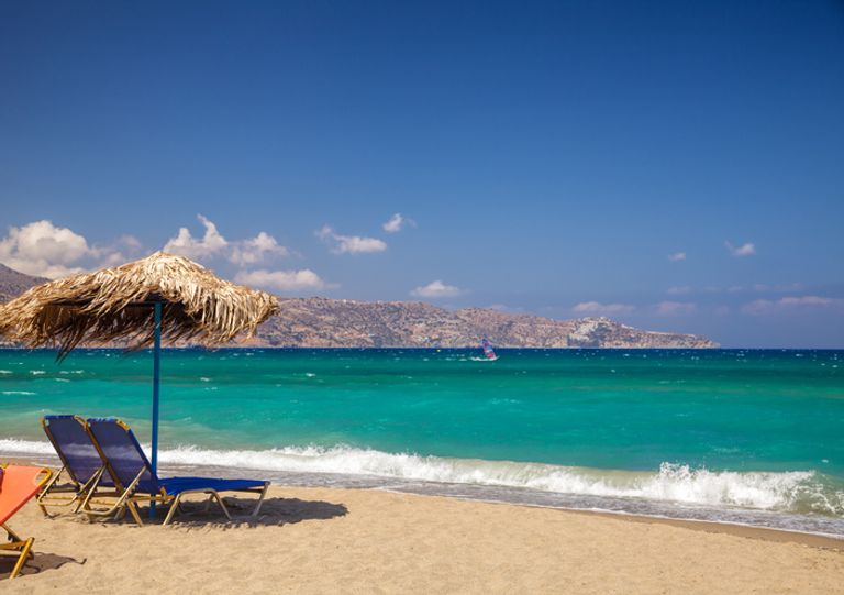 Sunloungers And Parasol On A Beach near Heraklion