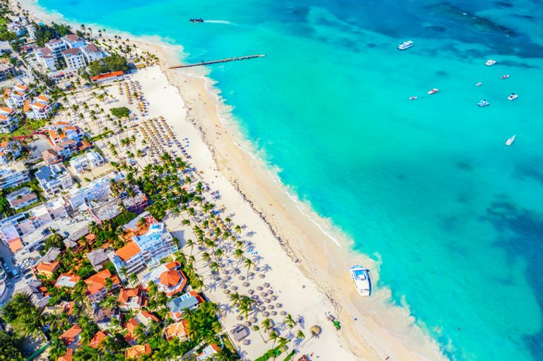 Aerial Drone View Of Beach With Palms And Boats. Punta Cana, Dominican Republic.