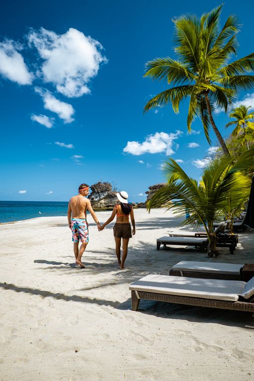 couple men and woman on vacation at the tropical Island of St Lucia beach,Anse Chastanet beach