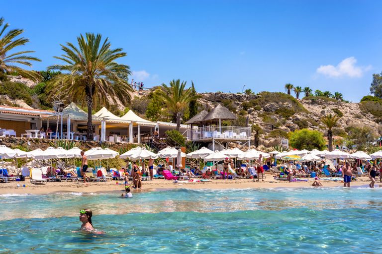 People Relaxing On Coral Bay Beach, One Of The Most Famous Beaches In Cyprus