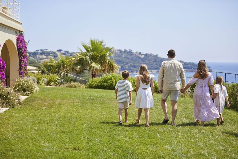 Family on holiday holding hands